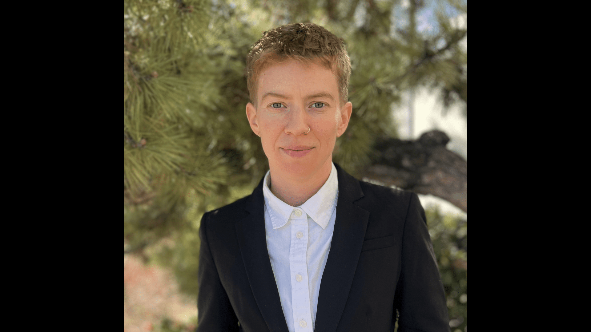 Headshot of Nat Williford with short sandy blonde hair and wearing business attire